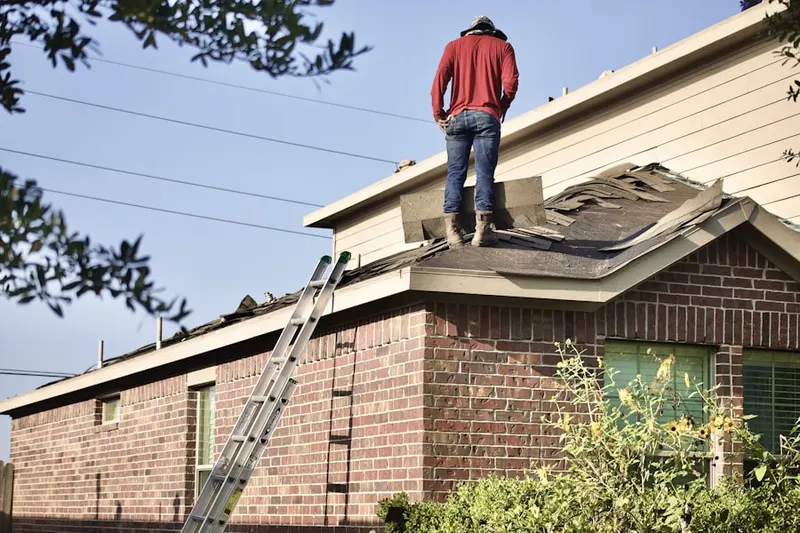 Professional roofer working on a residential roof in Bahama Beach